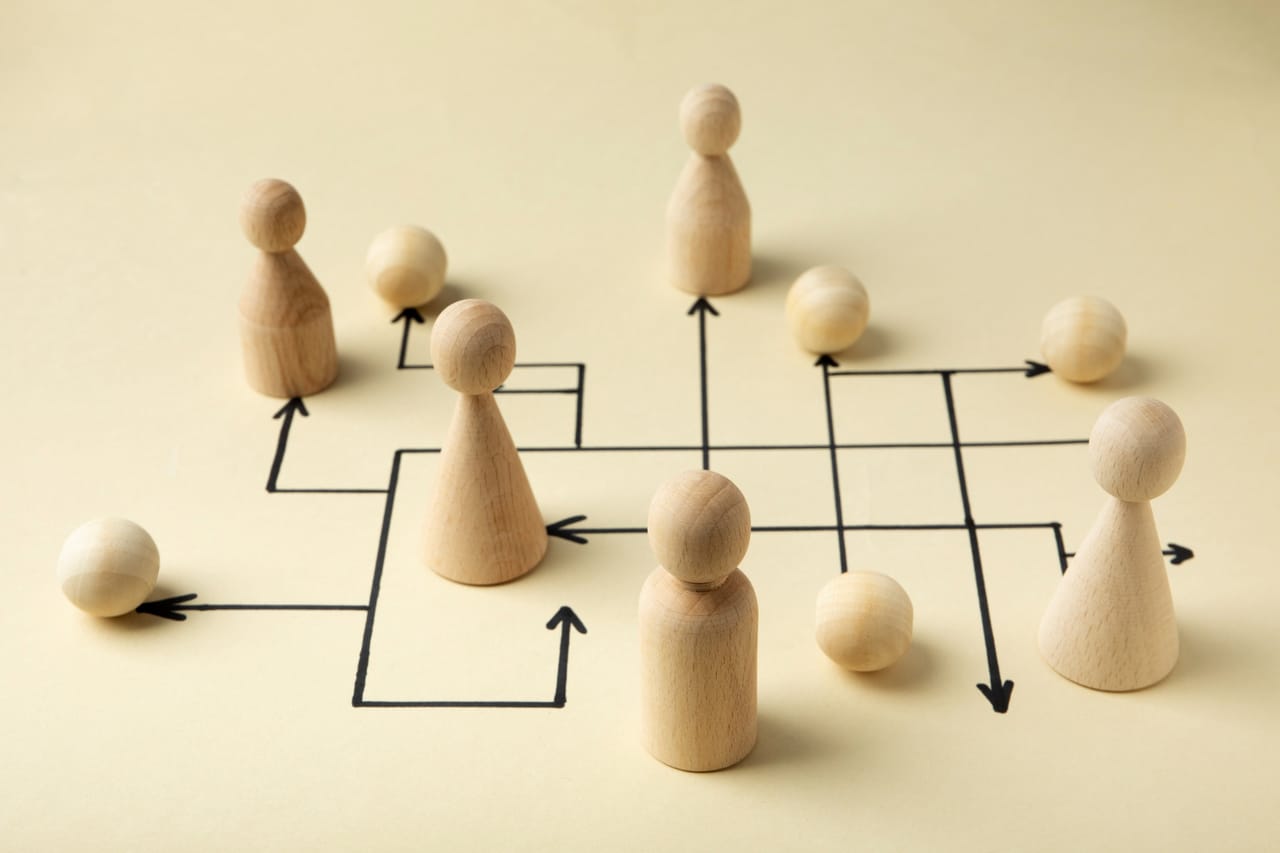 Wooden chess pawns arranged on a board, photographed from above